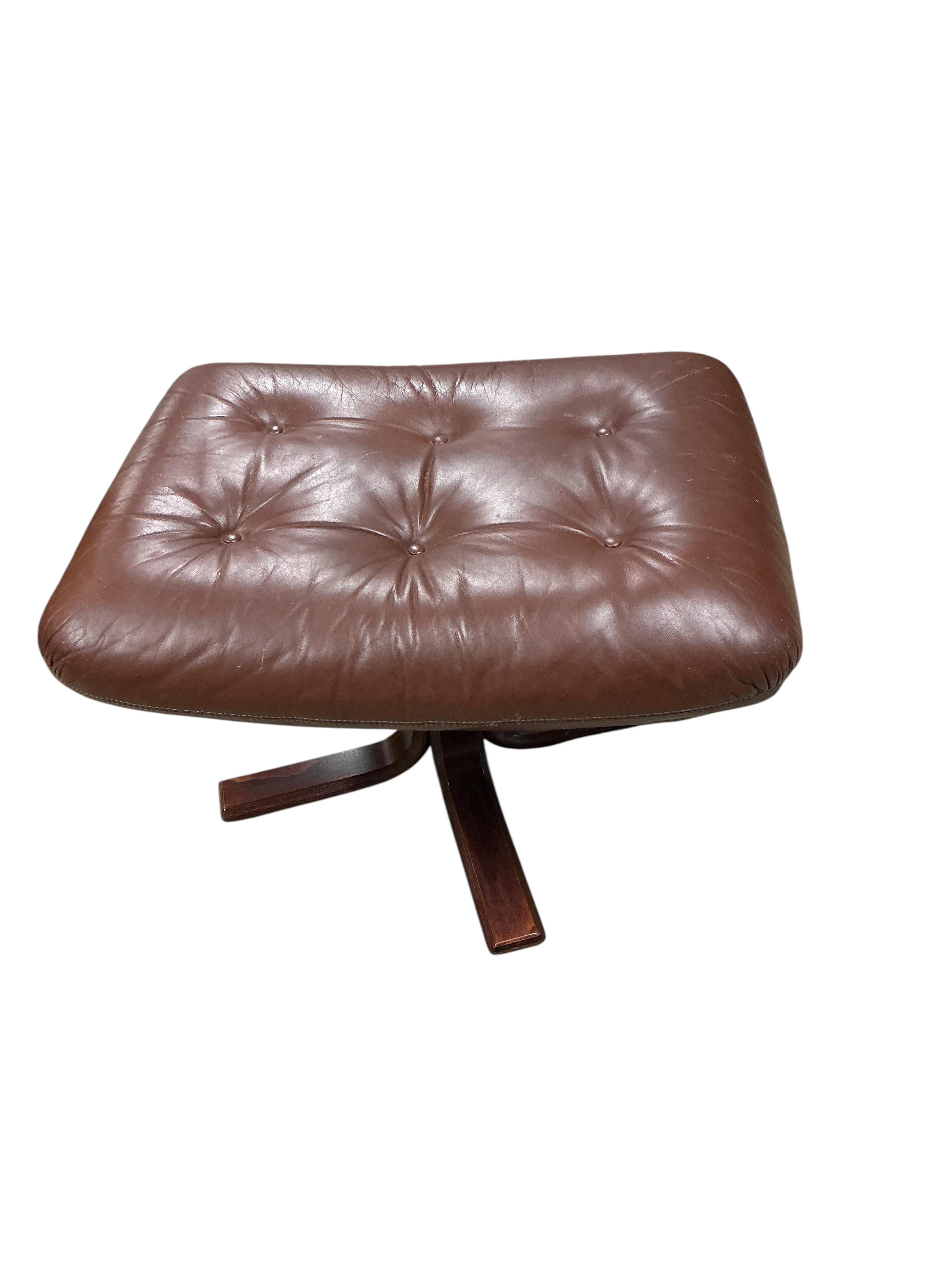 A mid century brown leather swivel chair, width 78cm, depth 90cm, height 96cm together with a footstool